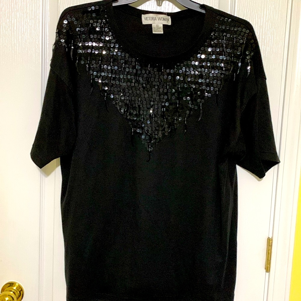 Black top with sequins on top front, short sleeve. By Victoria Woman.